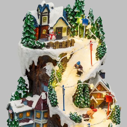 Villaggio natalizio innevato con luci e treno in movimento 21x21x38 cm