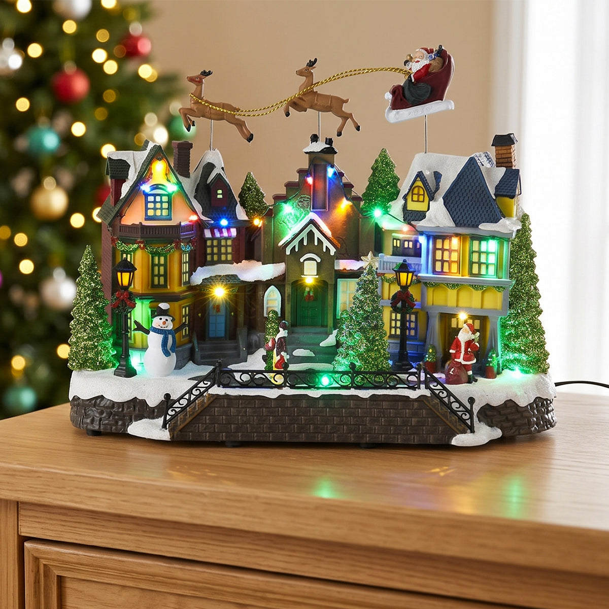 Villaggio di Natale animato con slitta volante e luci LED 39 cm